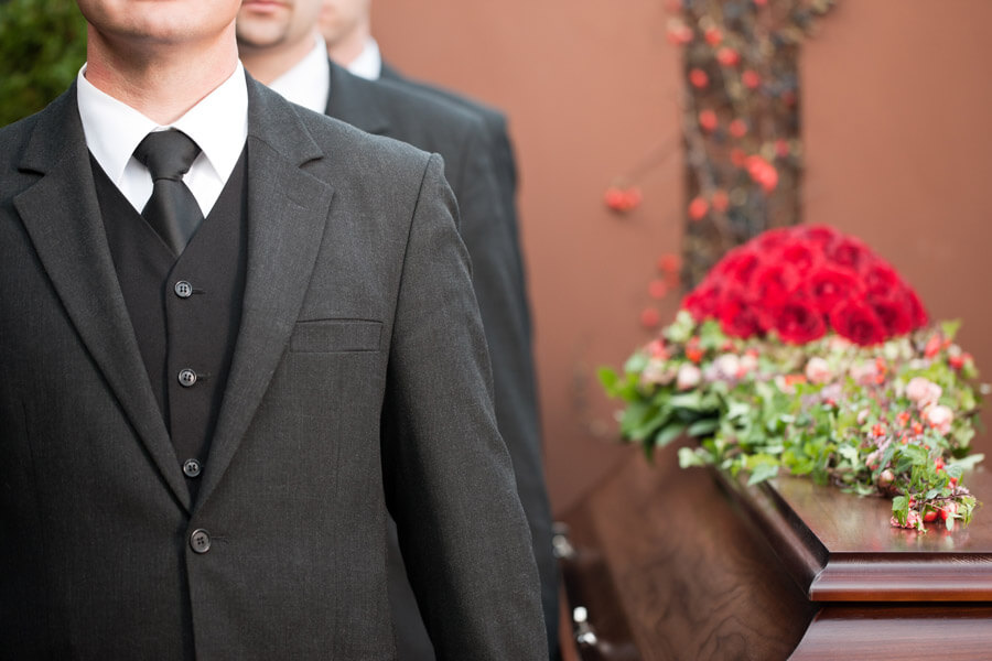 pall bearers carrying coffin